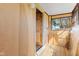The covered porch is constructed of unfinished walls and includes a wood door at 1857 Calvin St, Indianapolis, IN 46203