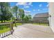 Outdoor living on this large wooden deck surrounded by lush trees and green lawn at 18904 Planer Dr, Noblesville, IN 46062