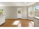 Bright dining area featuring wood-look flooring, lots of natural light, and a white door at 18904 Planer Dr, Noblesville, IN 46062