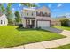 Charming two-story home featuring a well-manicured lawn, red shutters, and a two-car garage at 18904 Planer Dr, Noblesville, IN 46062