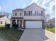 Charming two-story home with a two car garage, manicured lawn and classic architectural details at 18904 Planer Dr, Noblesville, IN 46062