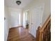 Inviting foyer featuring hardwood floors, and a staircase with wood railing, and a half bath at 18904 Planer Dr, Noblesville, IN 46062