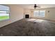 Spacious living room with neutral carpet, a fireplace, and bright windows at 18904 Planer Dr, Noblesville, IN 46062