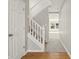 Bright and airy staircase with white railings and neutral carpet, leading to the upper level at 18904 Planer Dr, Noblesville, IN 46062