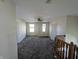Upstairs living area featuring neutral carpet, bright windows, and a ceiling fan at 18904 Planer Dr, Noblesville, IN 46062