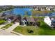 Aerial view of a well maintained brick home with a lake view and a green lawn at 1927 Westminster Pl, Columbus, IN 47201