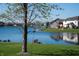 Picturesque backyard with a birdhouse and view of a calm lake, surrounded by neighborhood homes at 1927 Westminster Pl, Columbus, IN 47201