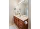 Bathroom features a wood vanity, beige countertop and a large mirror at 1927 Westminster Pl, Columbus, IN 47201