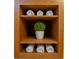 Bathroom storage cabinet with decorative plant and rolled-up towels at 1927 Westminster Pl, Columbus, IN 47201