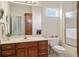 Bathroom features a wood vanity, shower with glass doors and a medicine cabinet at 1927 Westminster Pl, Columbus, IN 47201