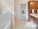 Well-lit bathroom featuring a tiled floor, built-in cabinets, and a shower with glass doors at 1927 Westminster Pl, Columbus, IN 47201