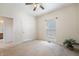 Well-lit bedroom with neutral carpet, ceiling fan, and ensuite access at 1927 Westminster Pl, Columbus, IN 47201