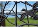 Close-up of the custom railing with artistic duck detail overlooking lush backyard and lake at 1927 Westminster Pl, Columbus, IN 47201