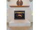 Close up of a fireplace with a tile surround and a wood mantle at 1927 Westminster Pl, Columbus, IN 47201