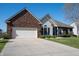 Charming brick and vinyl home featuring a well-manicured lawn and a two car garage at 1927 Westminster Pl, Columbus, IN 47201
