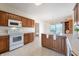 Bright kitchen with wooden cabinetry, white appliances and a view of the lake at 1927 Westminster Pl, Columbus, IN 47201