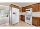 Spacious kitchen with white appliances, wooden cabinets, and white counter tops at 1927 Westminster Pl, Columbus, IN 47201