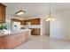Spacious eat-in kitchen with wooden cabinets, white appliances, and tile floors at 1927 Westminster Pl, Columbus, IN 47201