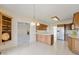 Open kitchen featuring a large island, tile floors, wood cabinets, and modern appliances at 1927 Westminster Pl, Columbus, IN 47201