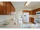 Well-maintained kitchen with classic wooden cabinets and white appliances at 1927 Westminster Pl, Columbus, IN 47201