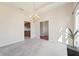 Cozy living room with a chandelier, neutral carpeting and a glimpse into the kitchen at 1927 Westminster Pl, Columbus, IN 47201