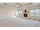 Spacious living room featuring a fireplace, neutral carpeting and tray ceilings at 1927 Westminster Pl, Columbus, IN 47201