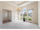 Bright living room with large windows, decorative chandelier, and neutral carpet at 1927 Westminster Pl, Columbus, IN 47201