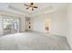 Generous main bedroom with sliding glass doors, tray ceiling, and easy access to the ensuite bathroom at 1927 Westminster Pl, Columbus, IN 47201