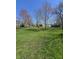 Large, grassy backyard featuring a few trees, ideal for outdoor relaxation and entertaining at 2018 Poplar St, Anderson, IN 46012