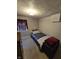 Cozy bedroom with neutral walls, carpet, bed and storage chest at 2018 Poplar St, Anderson, IN 46012