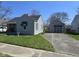 Cozy single-story home with gray siding, a detached garage and a concrete driveway at 2018 Poplar St, Anderson, IN 46012
