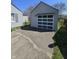 The detached garage shows a windowed door design and access to the backyard at 2018 Poplar St, Anderson, IN 46012