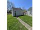 View of the detached garage with a side door and walkway to the main house at 2018 Poplar St, Anderson, IN 46012
