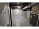 Spacious, unfinished basement with painted block walls, utility equipment and concrete floor at 2216 Bethel Ave, Indianapolis, IN 46203