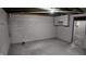 Basement features painted walls and concrete floors, offering a blank canvas at 2216 Bethel Ave, Indianapolis, IN 46203