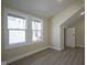 Bedroom featuring light-colored wood floors, white trim, and plenty of natural light from updated double-hung windows at 2216 Bethel Ave, Indianapolis, IN 46203