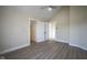 Bedroom featuring light-colored wood floors, white trim, and doorways leading to multiple rooms at 2216 Bethel Ave, Indianapolis, IN 46203