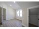 Bedroom featuring light-colored wood floors, white trim, and doorways leading to multiple rooms at 2216 Bethel Ave, Indianapolis, IN 46203