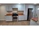Well-lit kitchen featuring stainless steel appliances, white cabinets, and natural wood countertops at 2216 Bethel Ave, Indianapolis, IN 46203
