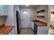 Bright kitchen with stainless steel refrigerator, wooden countertops, and open shelving at 2216 Bethel Ave, Indianapolis, IN 46203