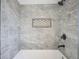 Modern tiled shower featuring gray tiling, black hardware, and a built-in niche at 2216 Bethel Ave, Indianapolis, IN 46203
