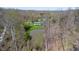 Picturesque aerial shot capturing the home, pond, and surrounding wooded area, showcasing the property's serenity at 2455 Lenvoil Rd, Martinsville, IN 46151