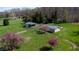 Idyllic aerial view capturing the home, garage, pond, and vibrant foliage, highlighting the property's charm at 2455 Lenvoil Rd, Martinsville, IN 46151