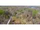 Expansive aerial view showcasing the wooded landscape surrounding the property offering privacy at 2455 Lenvoil Rd, Martinsville, IN 46151