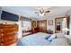 Comfortable bedroom with a large window, ceiling fan, and carpeted floor at 2455 Lenvoil Rd, Martinsville, IN 46151