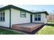 A charming single-story home featuring a wooden deck, siding, and a well-maintained lawn at 2455 Lenvoil Rd, Martinsville, IN 46151