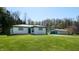 A charming home featuring a well-manicured lawn and a detached garage with ample outdoor space at 2455 Lenvoil Rd, Martinsville, IN 46151