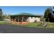 Inviting home featuring a covered porch, wooden deck, and lush green lawn at 2455 Lenvoil Rd, Martinsville, IN 46151