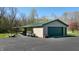 A detached two-car garage with a large driveway, providing ample parking and storage space at 2455 Lenvoil Rd, Martinsville, IN 46151