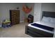 Bright bedroom with playful décor, including a teddy bear, a toy hammock, and a wooden dresser at 2599 Liatris Dr, Plainfield, IN 46168
